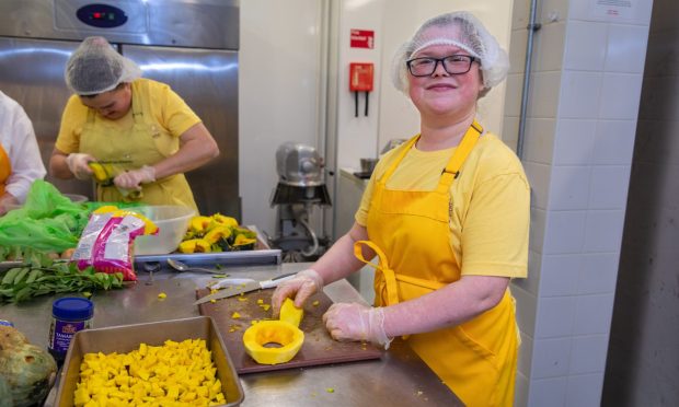 Chloe Hutchison prepping squash in the Rothes Halls kitchen.