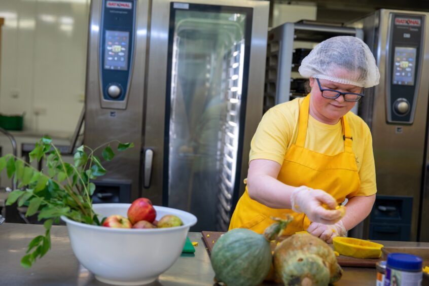 Chloe busy prepping vegetables in the kitchen.