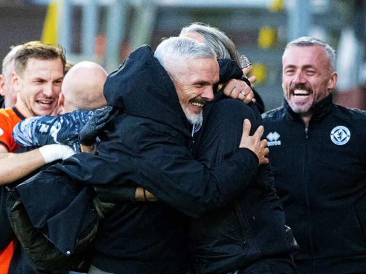 Jim Goodwin celebrates with his staff at Tannadice. Image: SNS