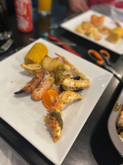 A photo of some of the seafood on a while plate.