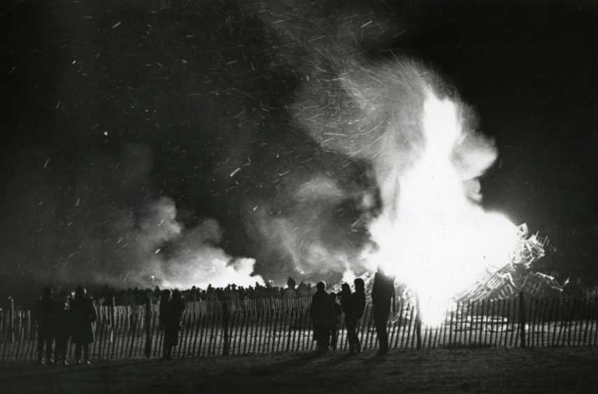 People silhouetted against the bonfire at Baxter Park in Dundee in 1984. 