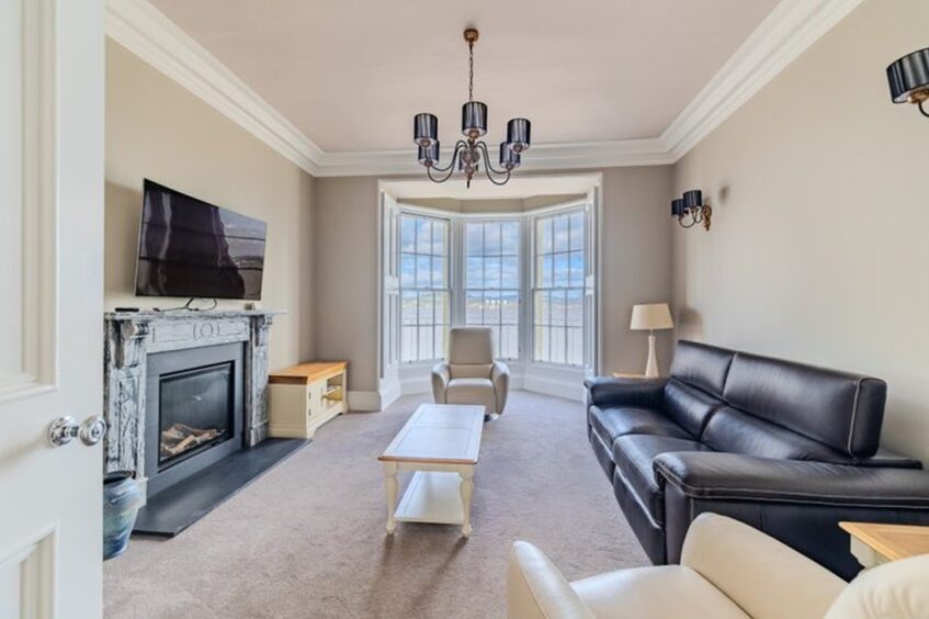 The living room with bay windows overlooking the Tay. 