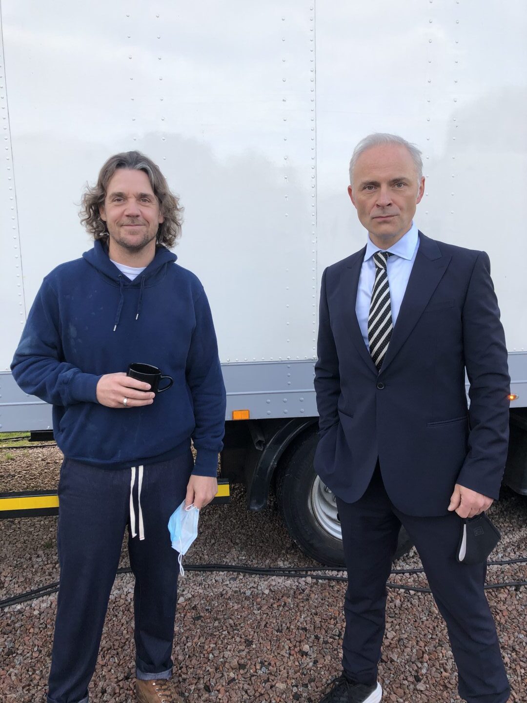 A crew member and Mark Bonnar hold Covid masks during a break in filming Guilt