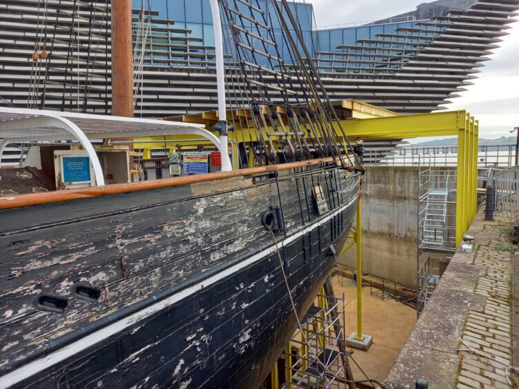 Yellow steel frame holding up the stern of RRS Discovery as restoration work takes place. 