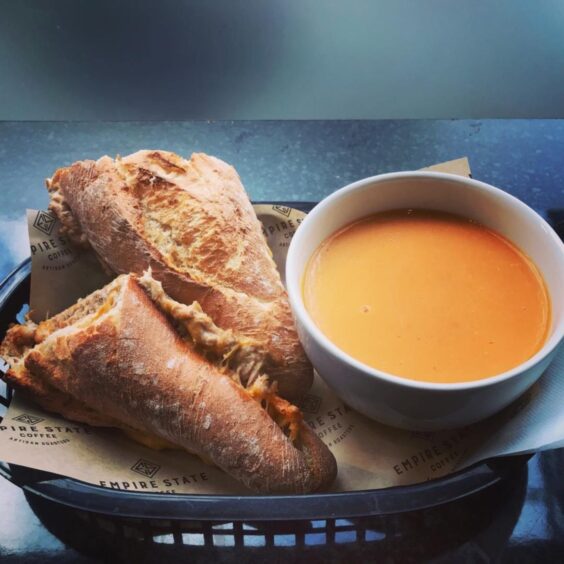 A bowl of soup and toasted panini from Empire State Coffee.