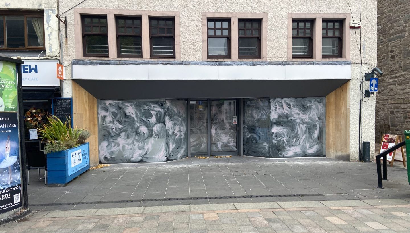 empty high street shop with whitewashed windows