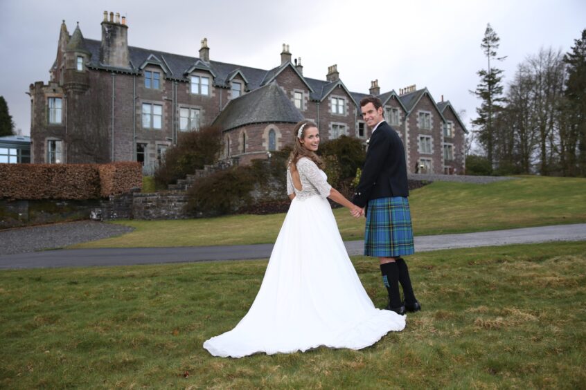 Andy and Kim on their wedding day in front of the hotel