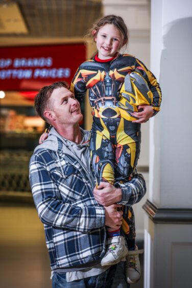 Imogen Irvine, eight, dressed as Bumblebee with her dad Lee. 