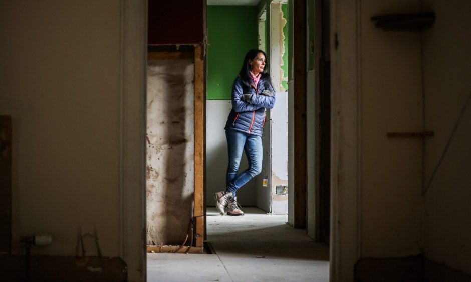 Gayle in her flood-damaged cottage in Kinnettles, Angus - a year on from Storm Babet. Image: Mhairi Edwards/DC Thomson.