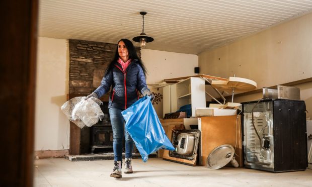 Gayle in her cottage in Kinnettles, Angus, which is still uninhabitable a year after being flooded by Storm Babet. Image: Mhairi Edwards/DC Thomson.