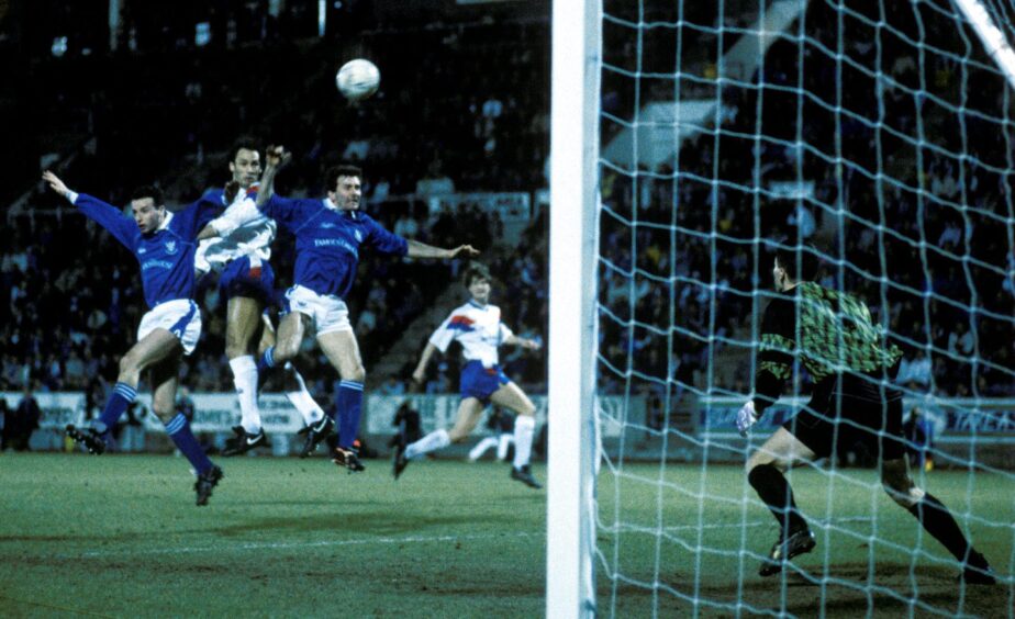 Raymond Stewart challenges for a header against Mark Hateley at McDiarmid Park.