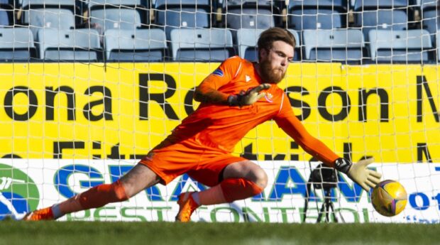 Zander Clark's penalty save helped St Johnstone win their first Scottish Cup tie at Dens.