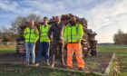 For men standing in front of pile of pallets ahead of Perth bonfire