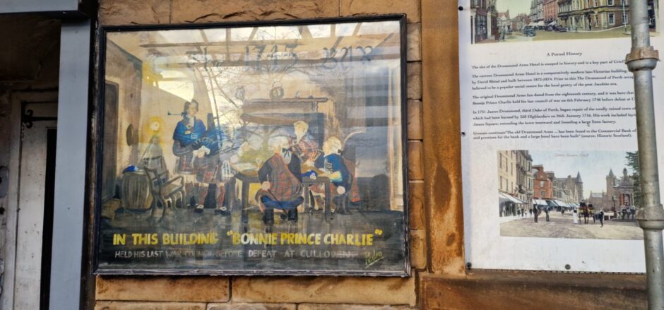 Painting of gathering featuring Bonnie Prince Charlie beside door of Drummond Arms Hotel