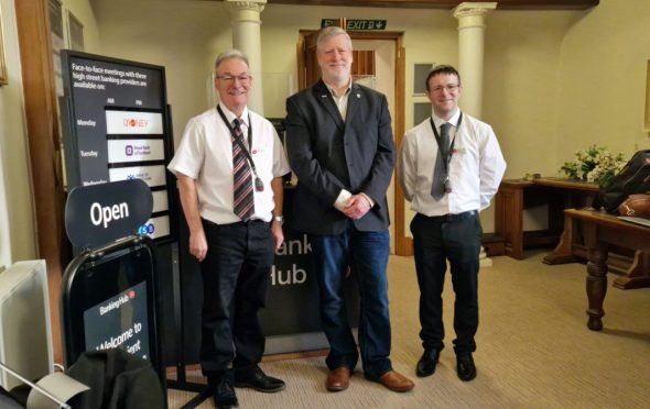 Councillor Steven Carr and John and Craig McNicoll in front of the counter at the Auchterarder banking hub.