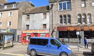 View of Himalaya restaurant with run down two storeys above