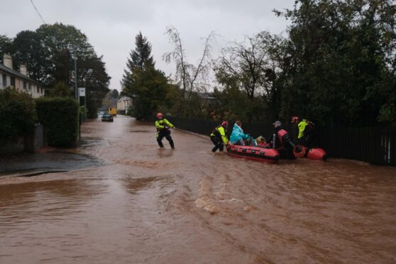 Rescuers take Brechin residents to safety during Storm Babet.  Image: Paul Reid