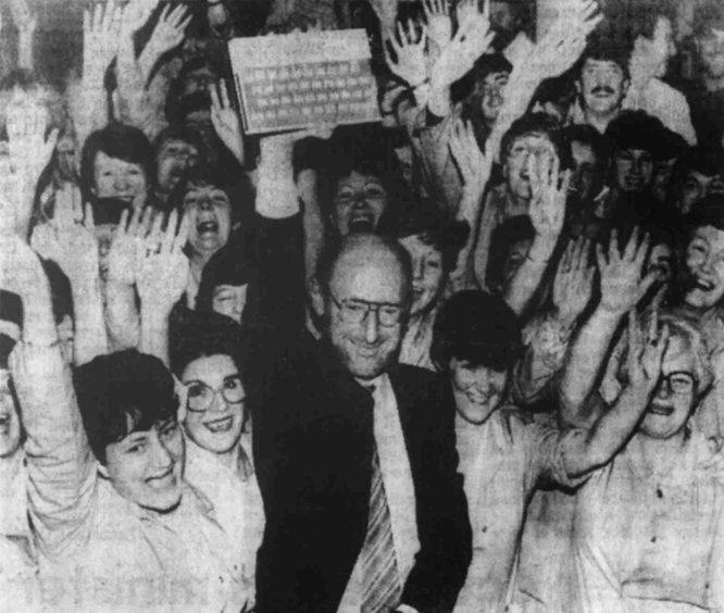 Sir Clive with Timex Dundee workers and the special console. 