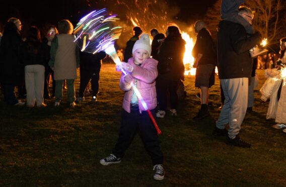 Emily Swankie, 7, with her glow wand at Kirriemuir Hill. Image: Paul Reid