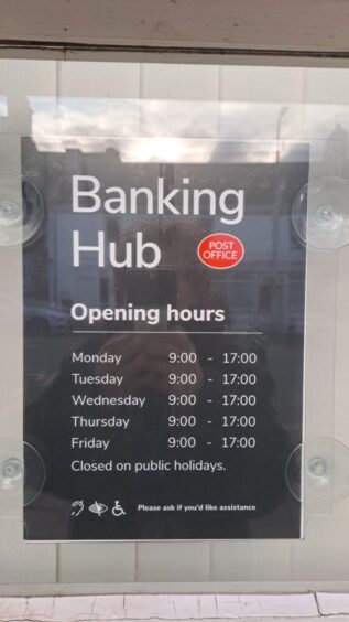 Sign with banking hub opening hours