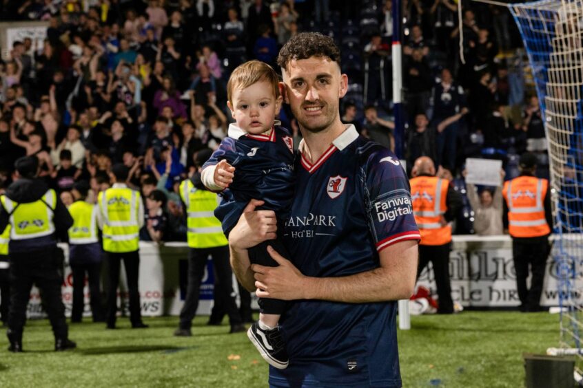 Shaun Byrne with his first son, Colby, after Raith Rovers' play-off win over Partick Thistle last season.