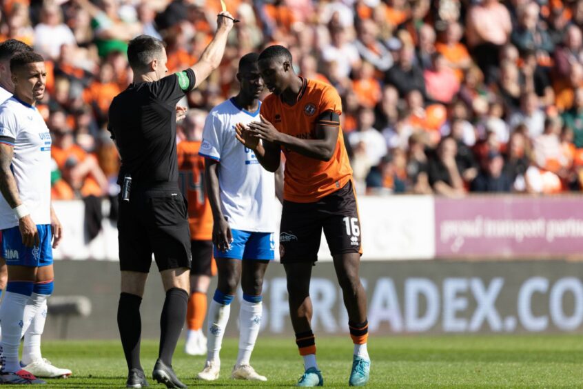 Don Robertson flashes a yellow card at Emmanuel Adegboyega for a challenge on Connor Barron that had Gers fans howling for a red