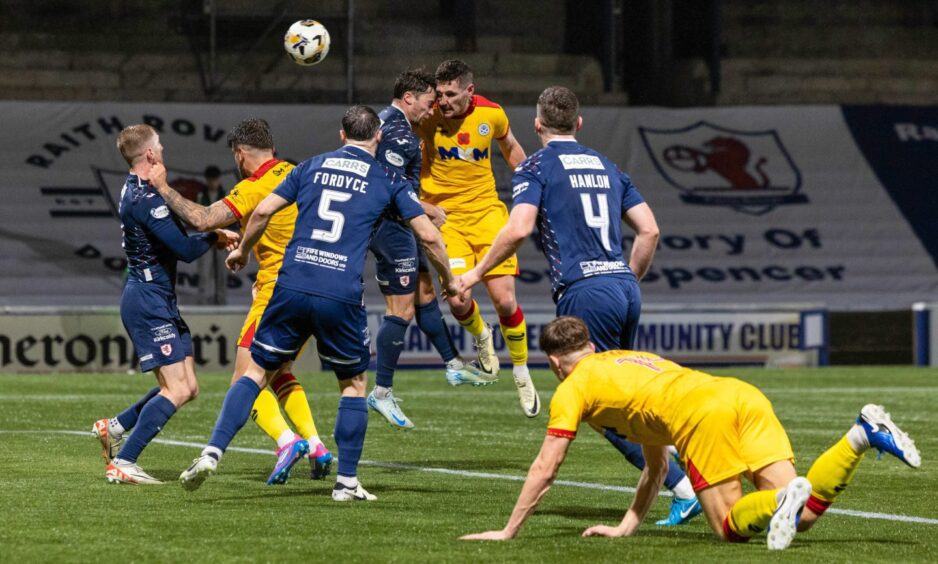 Raith Rovers defend a high ball in their own box against Ayr United.