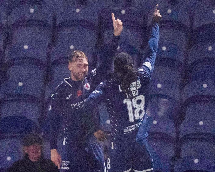 Raith Rovers duo Lewis Jamieson and Fankaty Dabo point into the air in celebration.