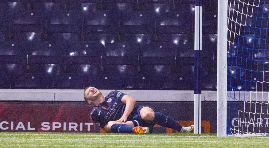 Callum Smith writhes in agony on the ground and holds his right leg.