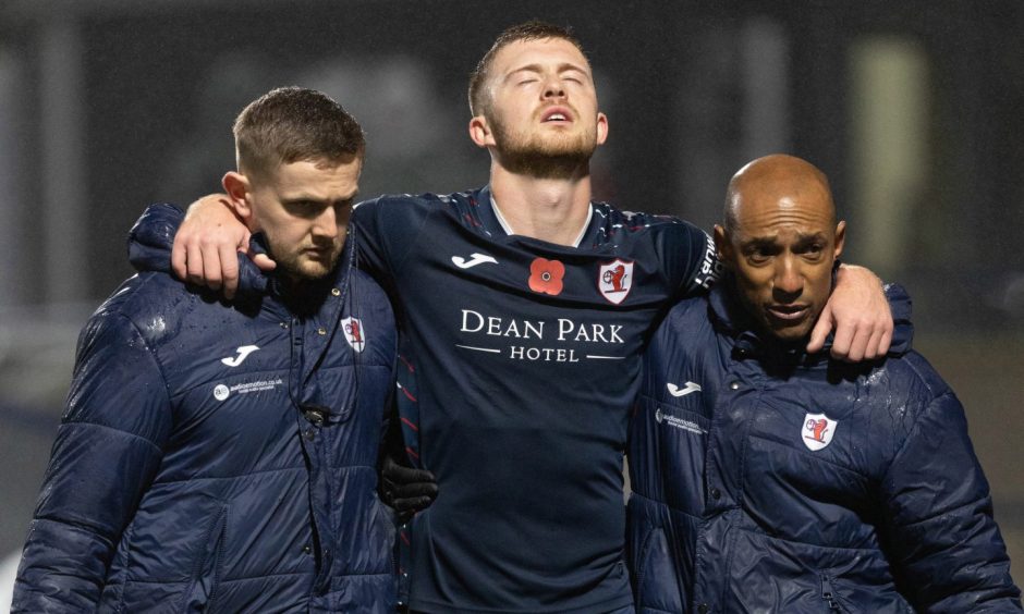 Callum Smith is helped off the pitch against Ayr United after picking up an injury.