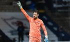 Raith Rovers goalkeeper Kevin Dabrowski raises his right arm in the air in celebration.