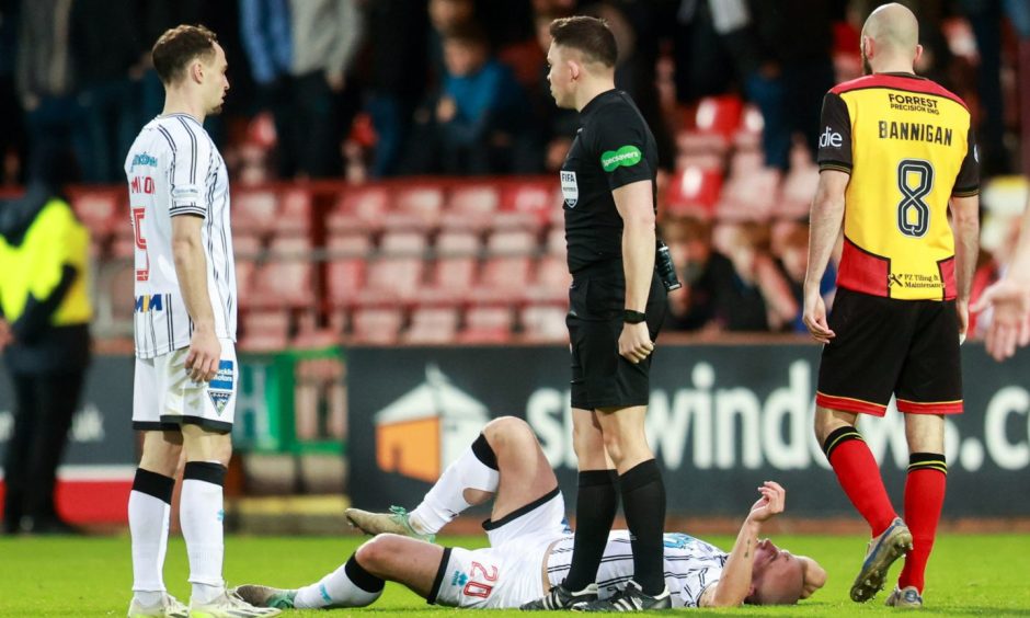 Chris Kane lies injured during the defeat to Partick Thistle.