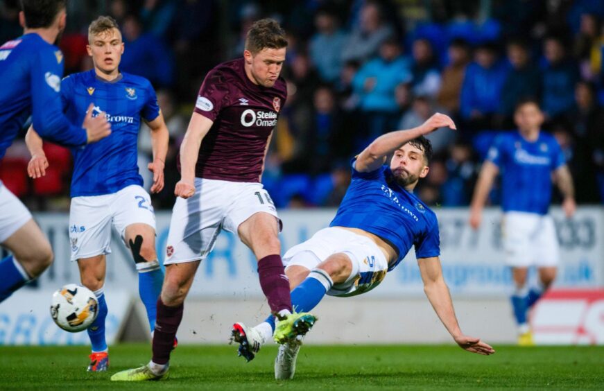 Jack Sanders and Hearts' Blair Spittal in action.