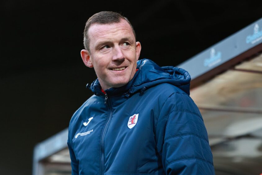 Raith Rovers boss Neill Collins looks to his left.