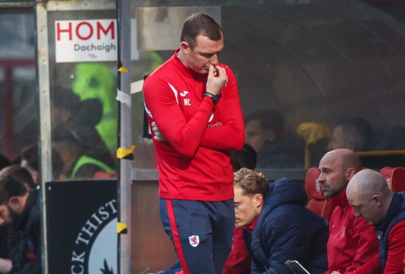 Former Raith manager Neill Collins looks at the ground and pinches his nose.