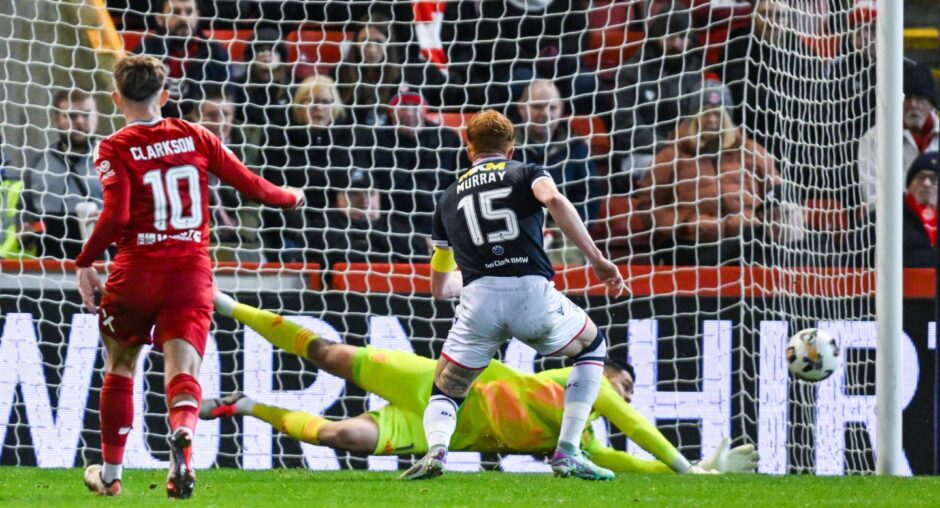 Aberdeen goalkeeper Dimitar Mitov dives to his left to keep out Simon Murray's penalty for Dundee.