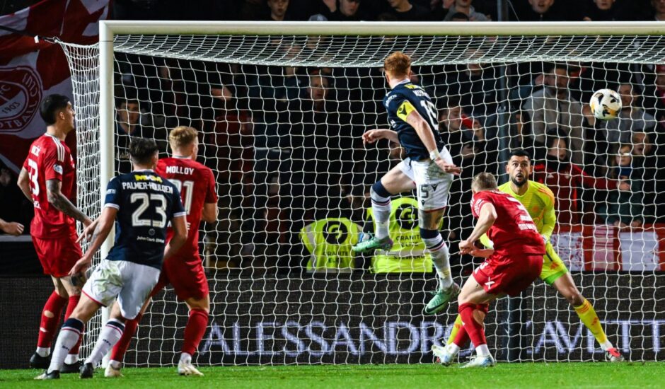 Simon Murray rises above the Aberdeen defence to pull Dundee back to 2-1 down.