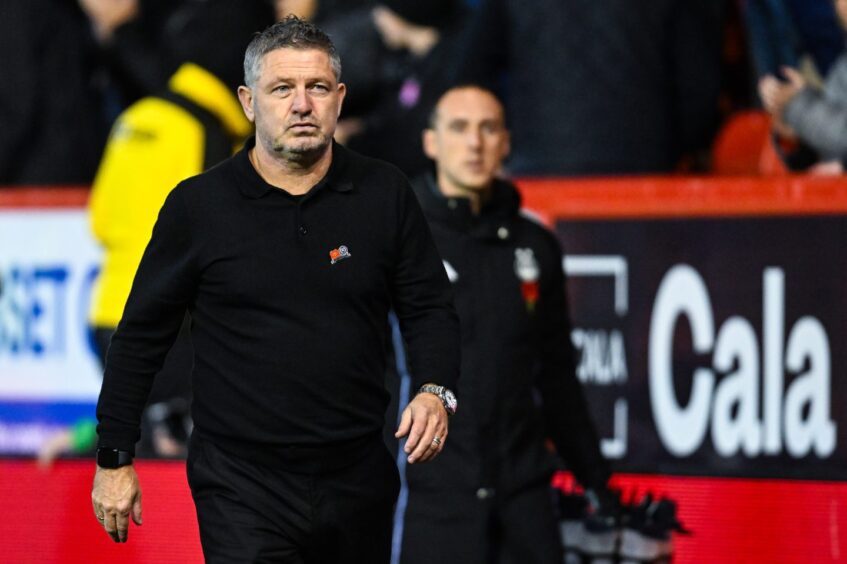 Dundee boss Tony Docherty walks off at Pittodrie.