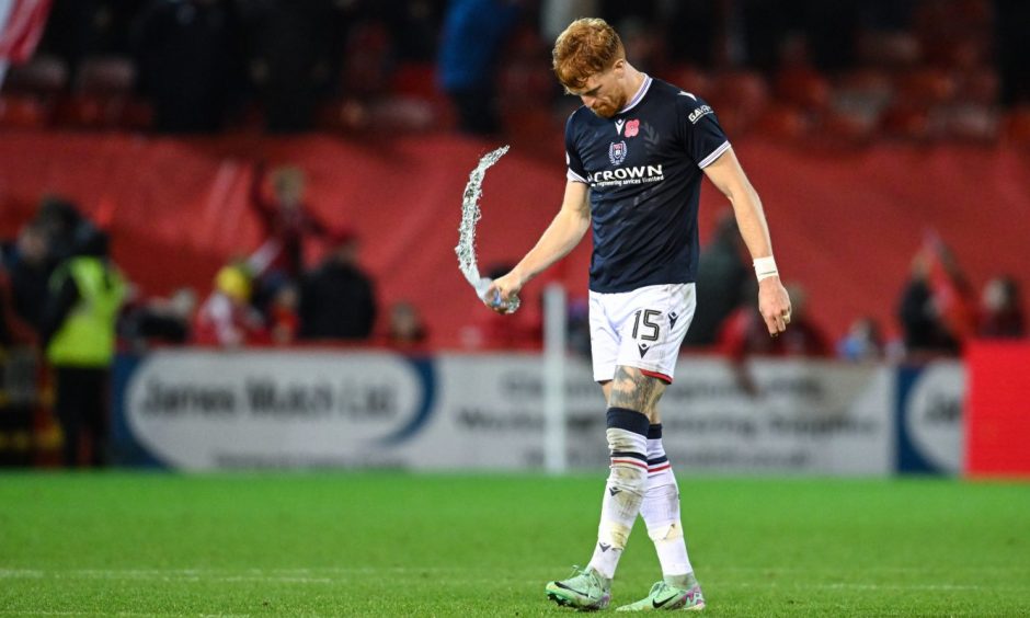 A disappointed Simon Murray trudges off at full-time after Dundee's defeat to Aberdeen.