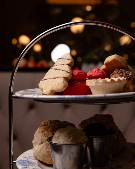 Christmas tree shaped biscuit tops a festive afternoon tea stand.