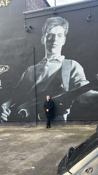 Mike Joyce at the Andy Rourke mural.