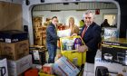 Gordon Brown with Pauline Buchan, of The Cottage Family Centre, and Simon McMahon, of Amazon. Image: Amazon.