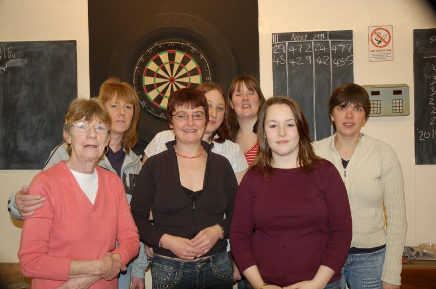 The Abbey team that competed in The Arbroath and District Ladies Darts League are pictured in 2007, standing in front of a dart board 