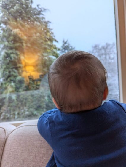 A baby's first snow in Perth.