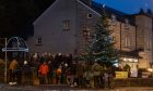 Bridge of Allan locals gather round the Christmas tree. Image: Gregor Boyd