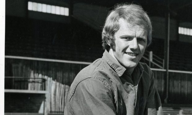 Kenny Aird kneeling with a ball at Muirton Park.