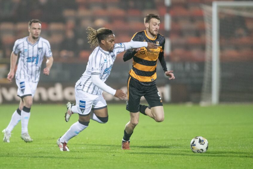 Dunfermline Athletic F.C. striker Dapo Mebude competes for the ball in a game against Alloa Athletic.