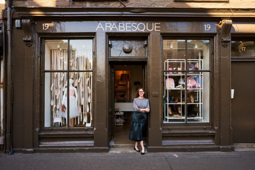 woman stands outside shop called Arabesque where you can do some Christmas shopping in Perth