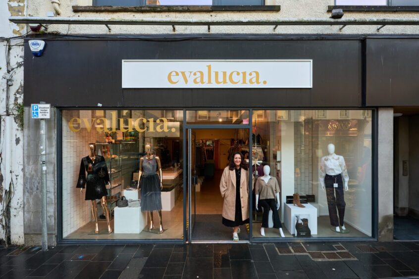 woman stands outside a shop called evalucia where you can do some Christmas shopping in Perth