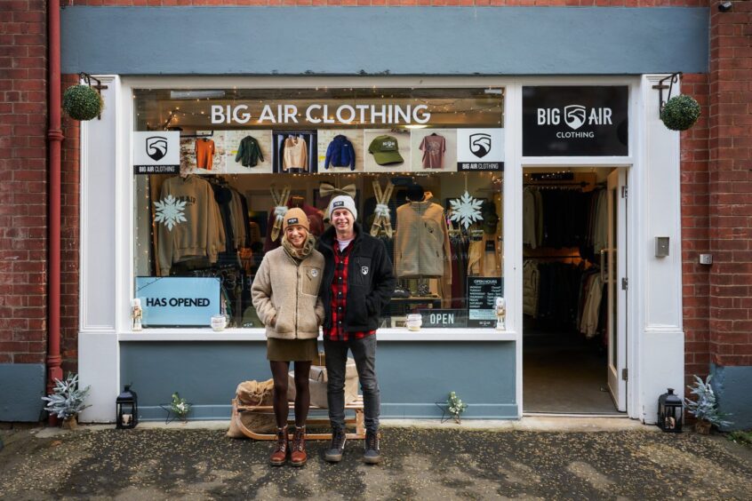 couple stands outside shop called Big Air Clothing where you can do some Christmas shopping in Perth